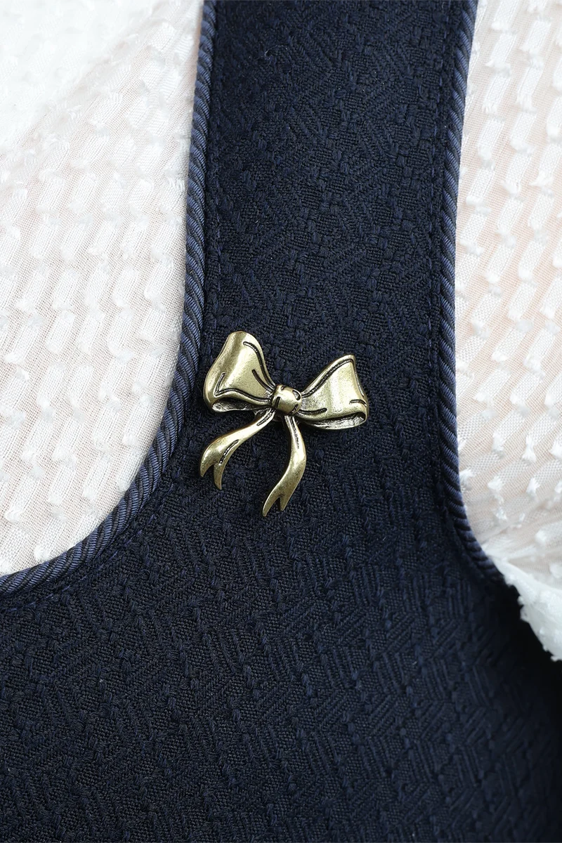 Pin geschwungene Schleife - altgold